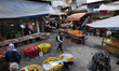 An Iranian woman walks along a local outdoor bazaar (Market) in the city of Rasht in Gilan...