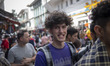 An Iranian man smiles as a reaction to the camera while walking along a local outdoor baza...