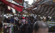 Iranian people walk along a local outdoor bazaar (Market) in the city of Rasht in Gilan pr...