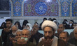 Iranian worshippers pray during an evening mass prayer ceremony in a holy shrine in the ci...