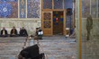 Two Iranian worshippers pray before an evening mass prayer ceremony in a holy shrine in th...