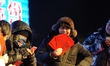 A woman with a red envelope to show at Zhaolin park in Harbin city of China on December 31...