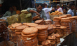 A person is selling bread on a roadside food stall during the holy month of Ramadan on the...