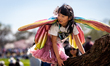 A young girl in rainbow wings climbs a cherry tree during the annual Cherry Blossom Festiv...