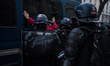 Riot police arrest a young protester during a rally against pension reform, in Paris, 28 M...
