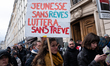 

A protester holds a sign that reads ''Youth without dreams will fight without truce'' as...