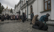 Believers and priest of Ukrainian Orthodox Church (Moscow Patriarchate) pray outside a chu...