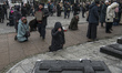 Believers and priest of Ukrainian Orthodox Church (Moscow Patriarchate) pray outside a chu...