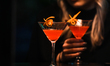 KRAKOW, POLAND - MARCH 28, 2023:A woman drinking cocktail in a restaurant, on March 28, 2...