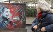 A passer-by looks at the Street Art 'Je Suis Ahmed' juest near the commemorative plaque in...