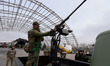 A Ukrainian serviceman checks a machine gun during a handover ceremony of donation of ten...