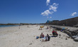 Daily life at the sea during a blue sky day at Pembroke beach with many locals and tourist...