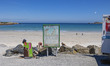 Daily life at the sea during a blue sky day at Pembroke beach with many locals and tourist...