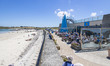 Daily life at the sea during a blue sky day at Pembroke beach with many locals and tourist...