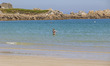Daily life at the sea during a blue sky day at Pembroke beach with many locals and tourist...