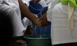 A priest washes the feet of the apostles during a representation of the Last Supper and th...