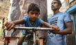 Catholic devotees carry a portrait of Jesus Christ during a religious procession to mark G...