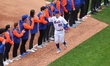 The New York Mets players, coaches and medical staff are introduced in a pre-game ceremony...