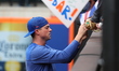 New York Mets relief pitcher Brooks Raley (25) sign for fans before the baseball game agai...