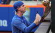 New York Mets relief pitcher Brooks Raley (25) sign for fans before the baseball game agai...