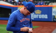New York Mets relief pitcher Drew Smith (40) sign for fans before the baseball game agains...