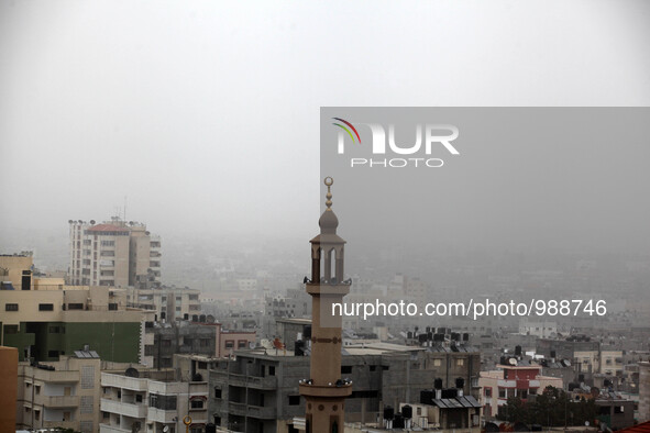 A picture taken on  08 January 2016.  shows a general view of Gaza City shrouded in a thick cloud of dust during a sandstorm. A dense sandst...
