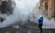 Biting frosts in St.Petersburg. A woman holding a child crossing the road in St. Petersbur...