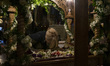 A woman worships the Epitaph on Good Friday in the church of Agios Eleftherios in Thessalo...