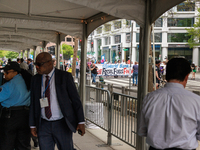People enter the 2023 IMF-World Bank meetings in Washington, D.C. on April 14, 2023 through a security area as climate change demonstrators...