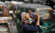 A thirsty rickshaw puller drinks water to get relief during a heatwave in Dhaka, Banglades...