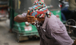 A rickshaw puller splashes water on his face to get relief during a heatwave in Dhaka, Ban...