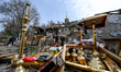 KOMYSHUVAKHA, UKRAINE - APRIL 16, 2023 - People slavage surviving items on the ruins of th...