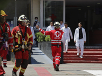 Members of the Mexican Red Cross evacuate a building during the First National Drill 2023 in Mexico, on april 19, 2023, where they carried o...