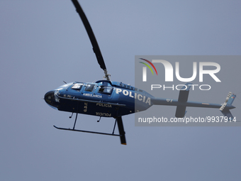 A Mexico City police helicopter flies over several buildings during the First National Drill 2023 in Mexico. (