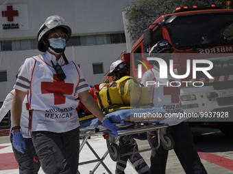 Members of the Mexican Red Cross attend to a person who was rescued by rappelling during the First National Drill 2023 in Mexico, on april 1...