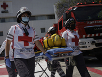 Members of the Mexican Red Cross attend to a person who was rescued by rappelling during the First National Drill 2023 in Mexico, on april 1...