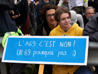 A protester holds a placard reading 'A69, it's no. A 69 why not ?' More than 8000 protesters marched 12km against the planned A69 highway. T...