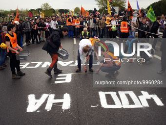 Activist from the 'Derniere Renovation' group paint on the RN126 the words '400ha of resistance'. More than 8000 protesters marched 12km aga...