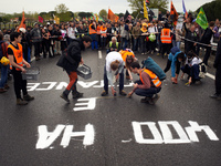 Activist from the 'Derniere Renovation' group paint on the RN126 the words '400ha of resistance'. More than 8000 protesters marched 12km aga...