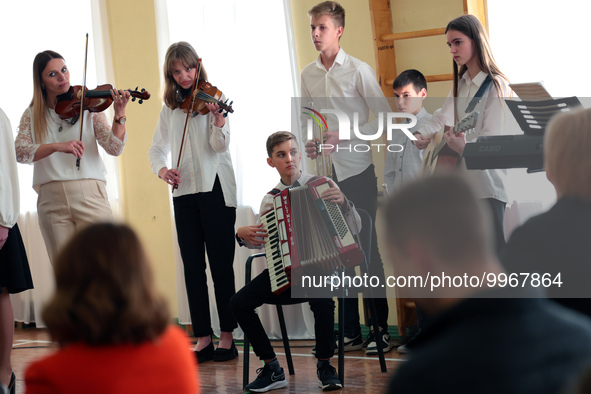 MOSTYSKA, UKRAINE - APRIL 21, 2023 - Students perform during a visit of First Lady of Poland Agata Kornhauser-Duda to Saint Queen Jadwiga  L...