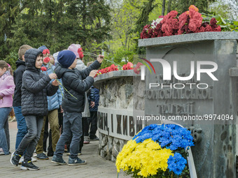 A group of schoolars lay flowers in the Chernobyl memorial during the celebrations in Kiev of the 37th anniversary of the Chernobyl nuclear...