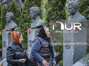A couple of women after leaving some flowers in the memorial of the dead Chernobyl workers during the celebrations in Kiev of the 37th anniv...