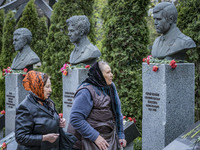 A couple of women after leaving some flowers in the memorial of the dead Chernobyl workers during the celebrations in Kiev of the 37th anniv...