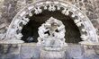 A person is seen visiting a monument located in the main gardens of Quinta da Regaleira. L...