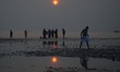 Indian Hindu devotees walking on the sea shore at the Gangasagar Island around 160 km sout...