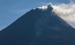 Mount Merapi, a volcanic mountain spews volcanic material as it erupts several times from...